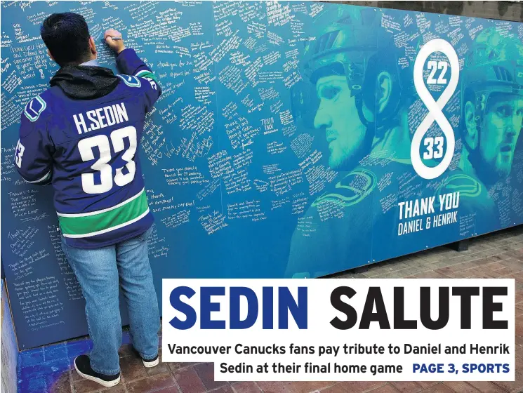  ?? GERRY KAHRMANN/PNG ?? Canucks fan Kevin Kedin Madarita signs a ‘Thank You’ wall for retiring twins Daniel and Henrik Sedin Thursday outside Rogers Arena.