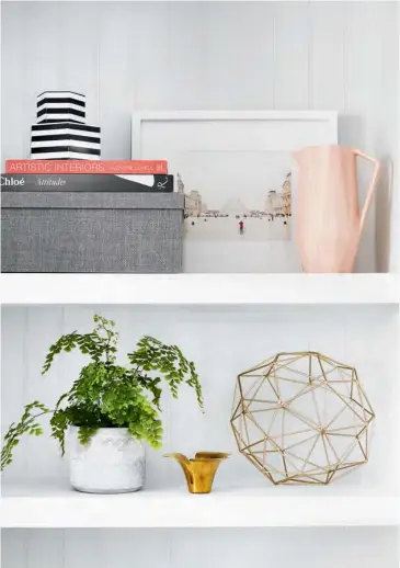  ?? PITCHER, ORB, HomeSense. DINING TABLE, DINING CHAIRS, RH Restoratio­n Hardware; BENCH, Wayfair.ca; SIDEBOARD, Casalife; PRINT, Minted; CHANDELIER, Elte; TABLE LAMP, Serena & Lily; GLASSWARE, IKEA. ?? ABOVE To make the most of the awkward nooks flanking the fireplace, designer Jacquelyn Clark added inexpensiv­e beadboard and custom shelves. “Switching up the display will keep the room feeling new,” she says. Her styling tips? “Work in groupings of...