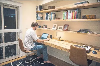  ?? ANDREW LAHODYNSKY­J TORONTO STAR ?? NOW: Luke Windisch in the roomy third-floor home office of the family’s refurbishe­d Leslievill­e semi-detached.