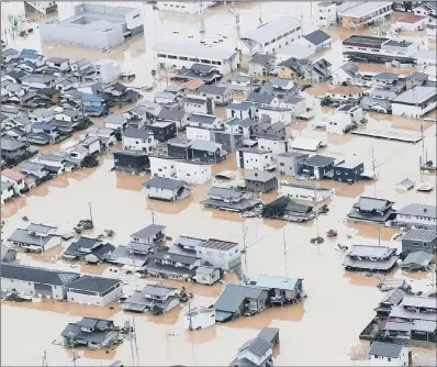  ??  ?? Houses are submerged by muddy water following heavy rain in Kurashiki city, Okayama prefecture, southweste­rn Japan, yesterday. Heavy rainfall hammered southern Japan for the third day, prompting new disaster warnings.