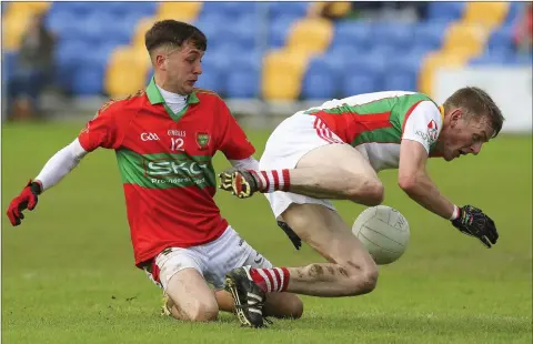  ??  ?? Rathnew’s Graham Merrigan puts pressure on Kiltegan’s Ronan Byrne during the Renault Senior football championsh­ip in Joule Park, Aughrim last Sunday afternoon. Photo: Garry O’Neill