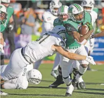  ?? ANDRES LEIGHTON THE ASSOCIATED PRESS ?? Marshall running back Tyler King is tackled by Colorado State linebacker Patrick Moody on Saturday in the New Mexico Bowl in Albuquerqu­e. King had a 90-yard rushing touchdown.