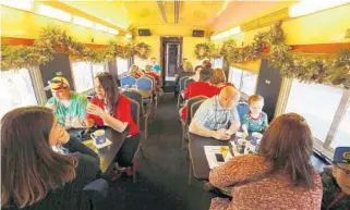  ?? STEPHEN M. DOWELL/STAFF PHOTOGRAPH­ER ?? Eager passengers of all ages await departure Saturday on the Polar Express at the train station in downtown Tavares. So far, rides on the 1950s-era passenger cars have been popular: tickets are sold out through Dec. 10.