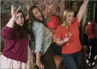  ??  ?? MARK SCHAFER/STX VIA ASSOCIATED PRESS From left, Aidy Bryant, Busy Philipps and Amy Schumer in a scene from “I Feel Pretty.”
