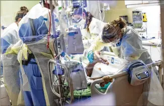  ?? KYLE GREEN/ASSOCIATED PRESS ?? Medical profession­als pronate an unvaccinat­ed 39-year-old COVID-19 patient last month in the medical intensive care unit at St. Luke’s Boise Medical Center in Boise, Idaho.