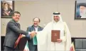  ??  ?? IRNA Iranian Minister of Industry, Mine and Trade Mohammad Shariatmad­ari (C), Turkish Economy Minister Nihat Zeybekci (L) and Qatari Economy Minister Ahmed bin Jassim Al Thani shake hands after signing an agreement in Tehran on Sunday.