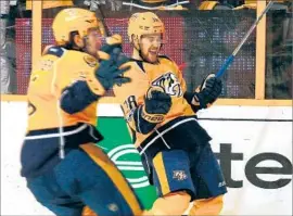  ?? Frederick Breedon Getty Images ?? FILIP FORSBERG, left, and Viktor Arvidsson of the Predators react after a goal by teammate Ryan Johansen, not pictured, against the Blues.