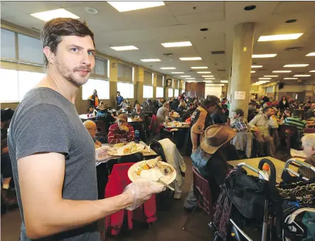  ?? DARREN MAKOWICHUK ?? Gareth Luke, Owner of Luke’s Drug Mart, helped serve lunch at the Calgary Drop-In and Rehab Centre Monday and said candidates in the municipal election should be talking more about homelessne­ss and housing affordabil­ity during the campaign, rather than...