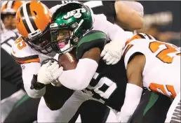  ?? Getty Images/tns ?? Cleveland Browns defensive tackle Larry Ogunjobi, left, and strong safety Eric Murray team up to tackle New York Jets running back Le’veon Bell for a short rushing gain in the first quarter, Sept. 16 at Metlife Stadium.