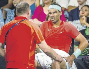  ?? ?? Rafael Nadal receives medical treatment on his hip during his loss to Jordan Thompson in Brisbane