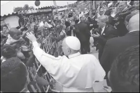  ?? AP PHOTO ?? Pope Francis’ greets people at his arrival at the San Francisco neighborho­od in Cartagena, Colombia.