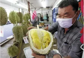  ?? ?? Prized fruit: Hock Beng showing the Musang King durian at his stall along Macalister road in Penang. — CHAN BOON Kai/the Star