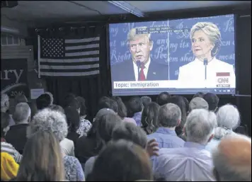  ?? JIM WILSON / THE NEW YORK TIMES ?? People attend a debate watch party held by the Democratic Volunteer Center of Mountain View, in Mountain View, Calif.