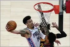  ?? JOHN BAZEMORE — THE ASSOCIATED PRESS ?? Sixers forward Danny Green puts up a shot against the Hawks’ Bruno Fernando, left, and John Collins, right, Monday night in Atlanta.