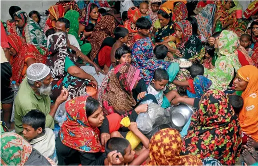  ?? AP ?? People crowd a shelter in Shyamnagar, Shatkhira, Bangladesh, as Cyclone Amphan makes landfall.