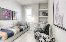  ??  ?? In another secondary bedroom, built-in shelves add a nice touch of character — not to mention extra storage space.