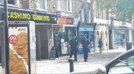  ??  ?? Armed police officers patrol streets in Ashford because of the terrorism threat