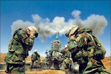  ?? Rick Loomis Los Angeles Times ?? U.S. MARINES fire an artillery weapon in southern Iraq days after the invasion started in March 2003.