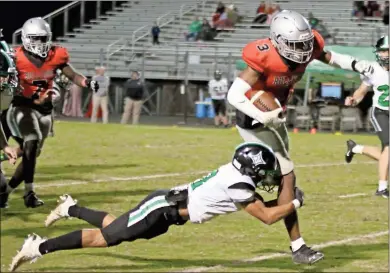  ?? Jeremy Stewart ?? Cedartown’s Jayden Johnson (3) tries to escape a tackle by Pickens’ Mykel Hand during Friday’s Region 7-4A game at Doc Ayers field in Cedartown. The Bulldogs won 52-21.