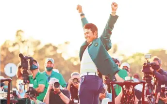  ??  ?? Hideki Matsuyama of Japan celebrates during the Green Jacket Ceremony after winning the Masters at Augusta National Golf Club in Augusta, Georgia.