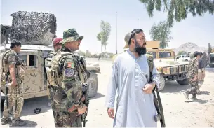  ??  ?? ON THE LOOKOUT: Afghan security personnel stand guard along the road amid ongoing fight between Afghan security forces and Taliban fighters in Kandahar on Friday.