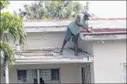  ?? JOHNNY JNO-BAPTISTE / ASSOCIATED PRESS ?? A homeowner makes last-minute repairs to his roof in preparatio­n for Hurricane Irma, in St. John’s, Antigua and Barbuda, Tuesday as Irma grew into a dangerous Category 5 storm, the most powerful seen in the Atlantic in over a decade.
