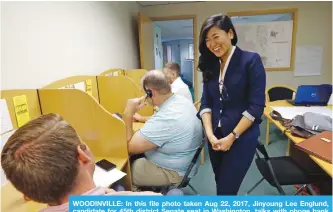  ??  ?? WOODINVILL­E: In this file photo taken Aug 22, 2017, Jinyoung Lee Englund, candidate for 45th district Senate seat in Washington, talks with phone bank volunteers at her campaign headquarte­rs. —AP