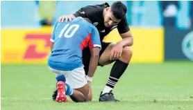  ??  ?? Helarius Axasman Kisting of Namibia is consoled by Rieko Ioane.