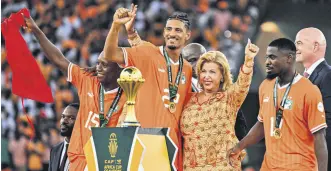  ?? ?? Ivory Coast’s Sebastien Haller (CL) poses with first lady Dominique Ouattara (CR) after winning the AFCON 2023 at Alassane Ouattara Olympic Stadium, Abidjan, Ivory Coast, Feb. 11, 2024.
