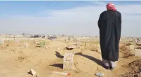  ?? (Stephen Kalin/Reuters) ?? THE FATHER of Atheer Ali stands beside his grave in the Gogjali Cemetery in eastern Mosul. Bottom: The ID card with the childhood photo of teenage Islamic State member Atheer Ali.