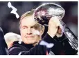  ??  ?? New England Patriots head coach Bill Belichick holds up the Vince Lombardi Trophy after a Patriots Super Bowl win.