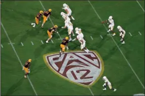  ?? The Associated Press ?? SUN DEVILS VS. GOLDEN EAGLES: The Pac-12 logo is displayed during the second half of an Aug. 29, 2019, game between Arizona State and Kent State, in Tempe, Ariz. The return of football isn’t likely to make much of a dent in the losses athletic department­s across the Pac-12 will ultimately incur because of the coronaviru­s pandemic. Faced with dramatic budget shortfalls, most schools in the league have already resorted to layoffs, furloughs, and cutting some sports entirely.