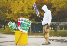  ?? BILL PUGLIANO ?? United Auto Workers member Brian Farr of Detroit walks the line at the General Motors Warren Transmissi­on plant on Oct. 25.