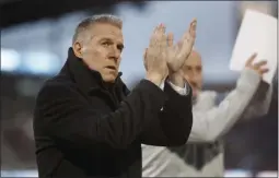  ?? DAVID ZALUBOWSKI ?? FILE - In this March 24, 2018, file photo, Sporting Kansas City’s Peter Vermes acknowledg­es fans as he takes the pitch to lead his team against the Colorado Rapids in an MLS soccer match in Commerce City, Colo.