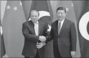  ?? AFP ?? Pakistan's Prime Minister Nawaz Sharif (left) shakes hands with China's President Xi Jinping, ahead of the Belt and Road Forum, in Beijing on Saturday.