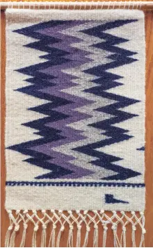  ??  ?? Relámpagos. Of this piece, Padilla-Haufmann says, “This is a small weaving that is not a traditiona­l pattern or size but uses churro wool and logwood. It would be considered contempora­ry and actually not allowed in market. Just for fun."