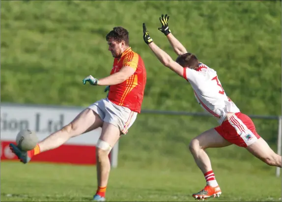  ??  ?? Mallow’s Killian O’Connor kicks a second half point past the outstretch­ed arms of An Gaeltacht’s Marc Ó Sé as the sides met in the Semi-Final of the Munster Football Intermedia­te Club Championsh­ip last weekend. Photo by Eric Barry