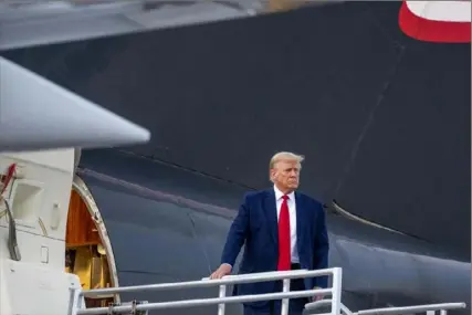  ?? Alex Brandon/Associated Press ?? Former President Donald Trump boards his plane after speaking with reporters before departing from Hartsfield­Jackson Atlanta Internatio­nal Airport on Thursday.
