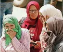  ?? [AP PHOTO] ?? In this photo dated June 4, women wait to receive the bodies of loved ones after the sinking of a boat carrying migrants the previous day, in the coastal city of Sfax, Tunisia.