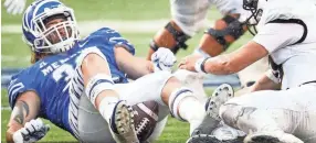  ??  ?? Memphis defender Jonathan Wilson (left) fails to recover a Central Florida fumble Saturday. MARK WEBER / THE COMMERCIAL APPEAL