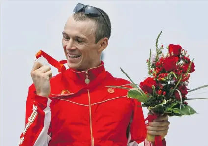  ?? SHAUN BOTTERILL/ GETTY IMAGES FILES ?? Simon Whitfield surprised the field by winning the silver medal for triathlon at the Beijing 2008 Olympic Games. Whitfield is taking part in this year’s Vancouver Sun Run but claims he is in no shape to contend for the top spot.