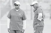 ?? AMY BETH BENNETT/SUN SENTINEL ?? Miami Dolphins general manager Chris Grier, left, and coach Brian Flores watch the team during a June practice session.