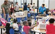  ?? Brett Coomer/Staff photograph­er ?? Children get settled in on the first day of school at Alief ISD’s Martinez Early Learning Center.