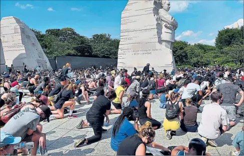  ?? OLIVIER DOULIERY / AFP ?? • En Washington, a los pies del monumento en honor a Martin Luther King Jr., histórico líder de los derechos civiles, cientos se arrodillar­on como tributo a George Floyd.