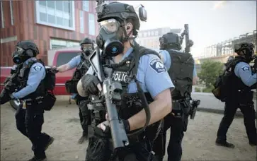  ?? Jason Armond Los Angeles Times ?? EXPERTS SAY a national use-of-force standard is the only way to ensure thousands of law enforcemen­t agencies take seriously the need for police reform. Above, Minneapoli­s police officers clear a protest last May.