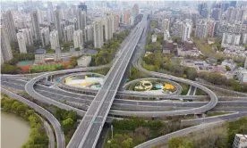  ?? Photograph: VCG/Getty Images ?? Normally packed roads in Shanghai’s Pudong area are empty on Friday morning after the coronaviru­s lockdown was extended.