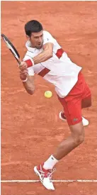  ?? GETTY IMAGES ?? Novak Djokovic plays a backhand against Juame Munar in the second round on Wednesday.