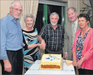  ??  ?? Tom and Lorraine ( formerly Sherlock) Futcher, and Alan ( whose grandmothe­r was Sherlock) and Barbara Leary cutting the celebrator­y cake at the Sherlock Clan gathering in Gurteen last Friday night. With them is Owen Duffy, second from right.