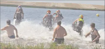  ?? Photos by Jamie Rieger ?? WATERCROSS­ED: The holders watch the racers leave the starting line at the Western Canadian Watercross Associatio­n event at Rattlesnak­e Dam site on June 24. The two-day competitio­n saw beginners, as well elite jet skiers who ar vying for a berth the...