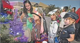  ?? Dan Watson/The Signal (See additional photos on signalscv.com) ?? Fairy princess Samantha Jackson hands out candy to The Mad Hatter, Braden Worsley, 5, and his friends at the third annual Trunk or Treat held at NorthPark Community Church in Valencia in 2016.
